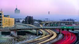 The road outside Kista lighted up by headlights of cars passing by