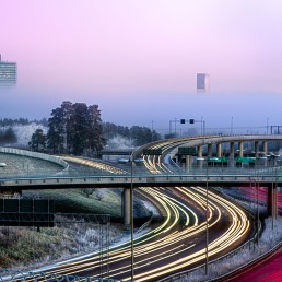 The road outside Kista lighted up by headlights of cars passing by