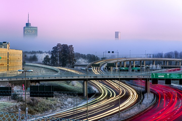 The road outside Kista lighted up by headlights of cars passing by