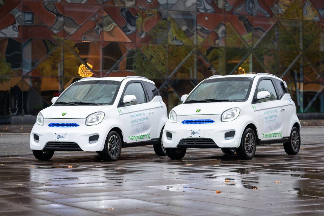 Two white cars parked outside